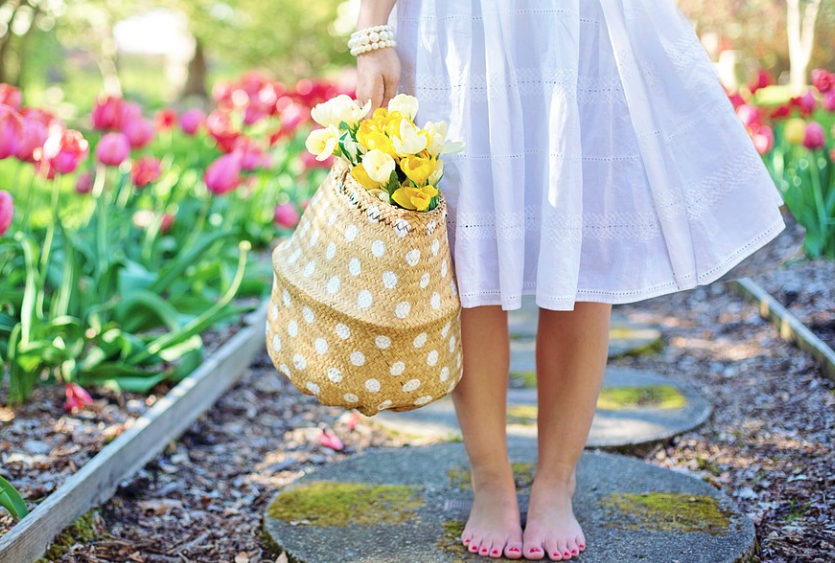 woman holding basket of tulips during spring