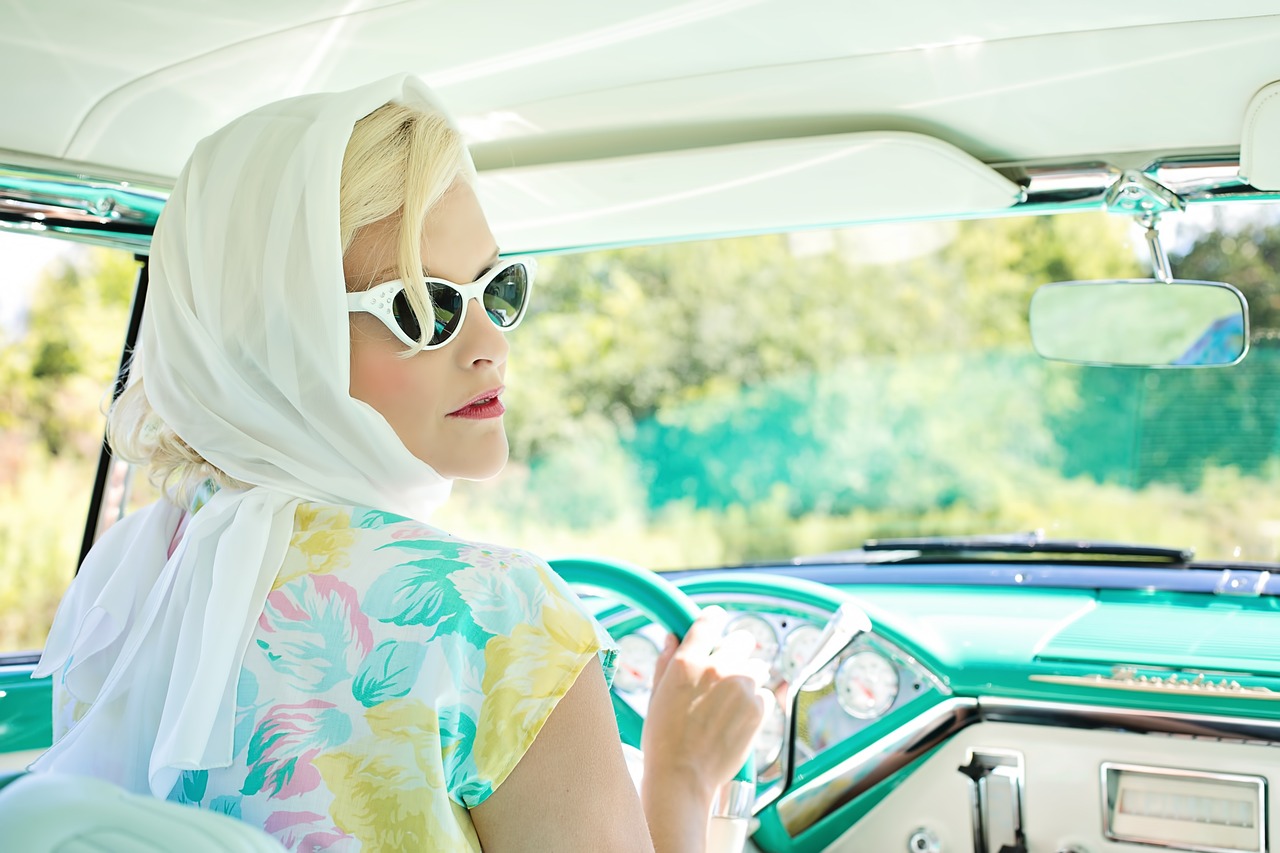 scent and memory feature image of woman driving Cadillac