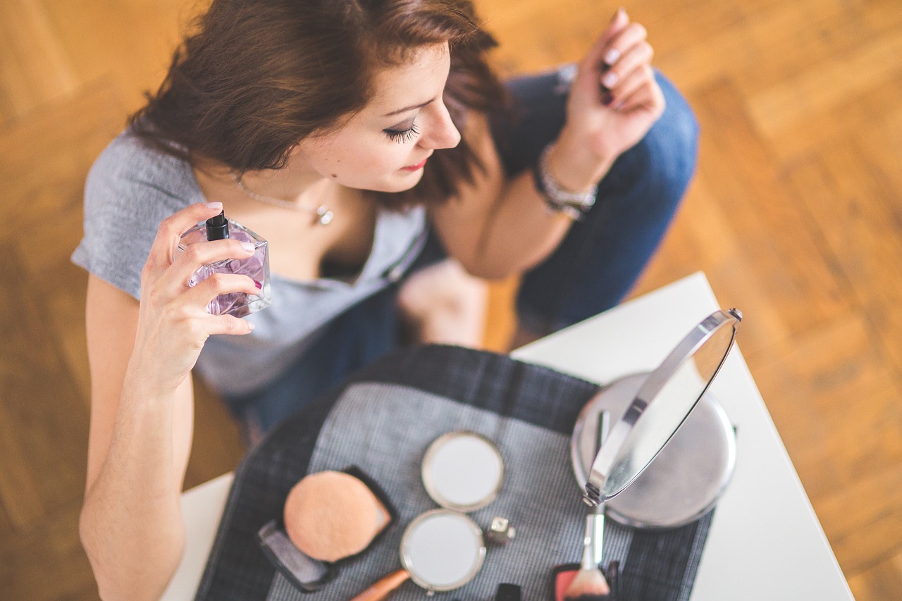 girl using perfumes and makeup