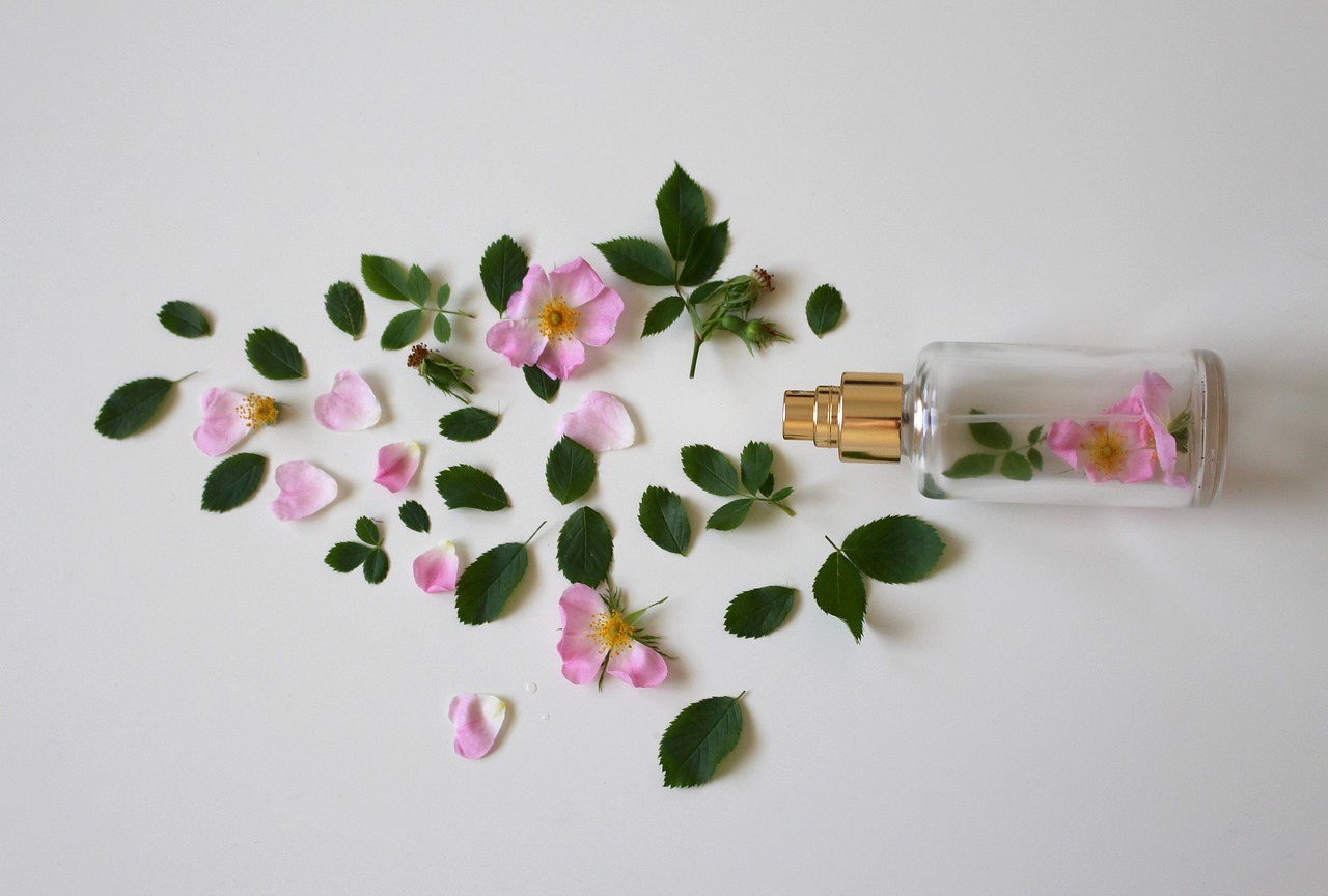 perfume bottle laid among roses