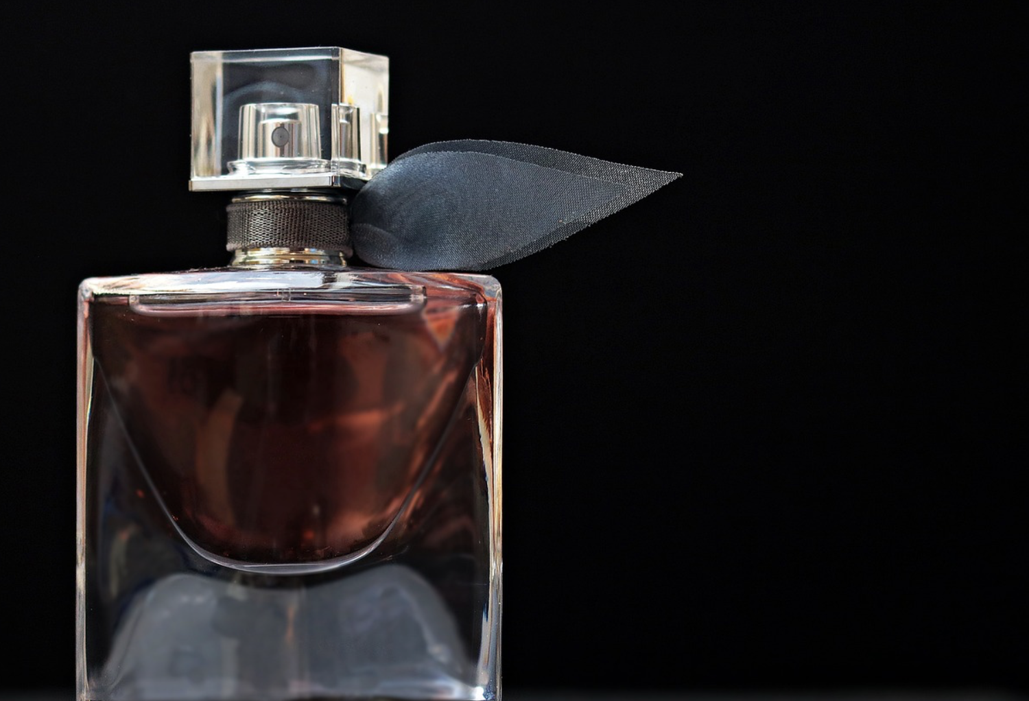 perfume bottle against black background