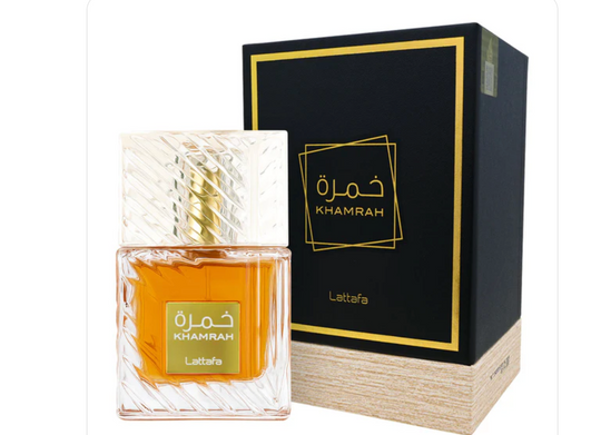 Lattafa Khamrah eau de parfum bottle with amber juice and gold Arabic-script label next to its black and gold box 