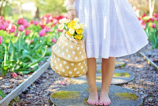 woman holding basket of tulips during spring 